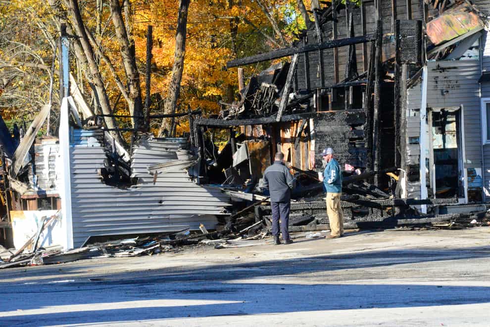 Investigators examine the site of a plane crash in Keene, N.H. on Saturday, Oct. 22, 2022. The Federal Aviation Administration said in a statement Saturday that a single-engine Beechcraft Sierra aircraft crashed Friday evening into a building north of Keene Dillant-Hopkins Airport. City officials said on their Facebook page that no one was injured in the building but that “those on the plane have perished.” (Kristopher Radder /The Brattleboro Reformer via AP)