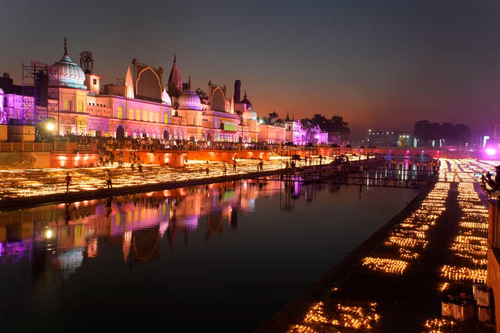 People light lamps on the banks of the river Saryu in Ayodhya (Rajesh Kumar Singh/AP)