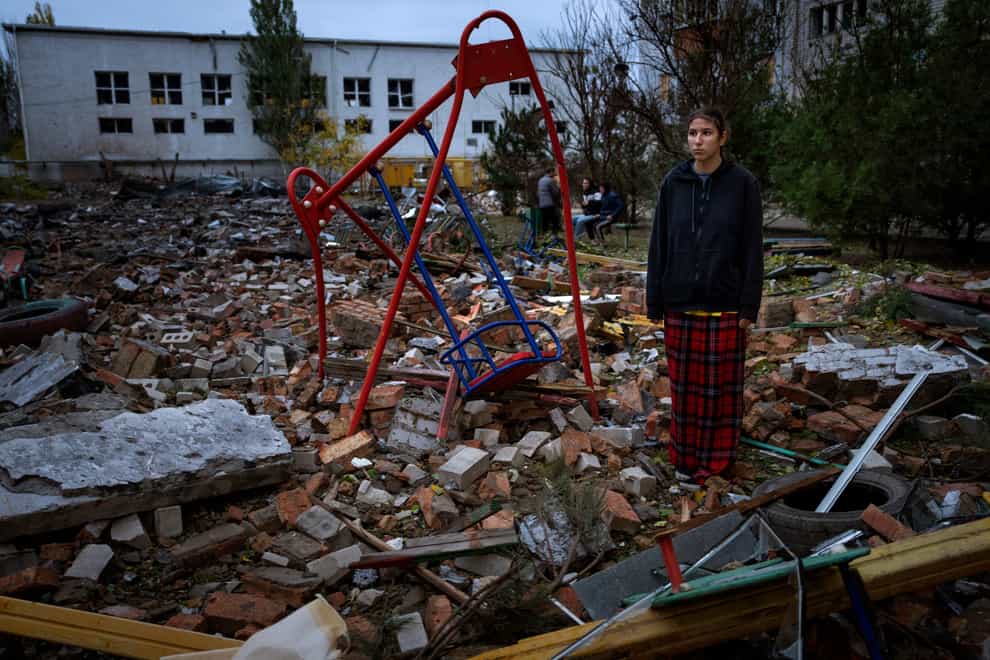 Taisiia Kovaliova, 15, stands amongst the rubble of a playground in front of her house in Mykolaiv (Emilio Morenatti/AP)