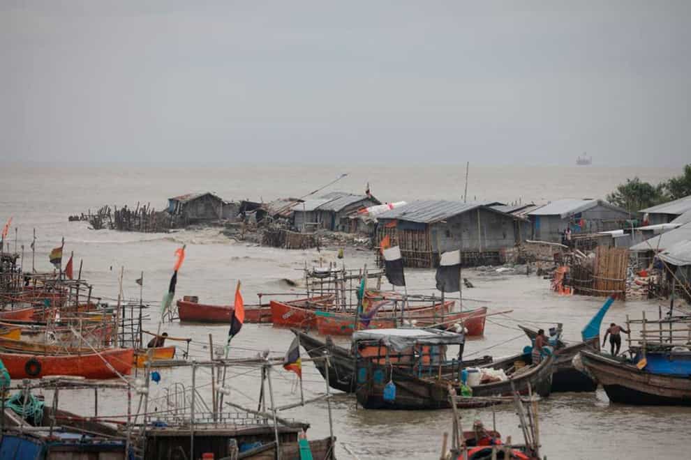 Fishermen on the Bay of Bengal coast secure their boats anticipating a storm in Patenga, Chittagong. Authorities in Bangladesh were evacuating hundreds of thousands of people as a tropical storm quickly approached (AP/PA)