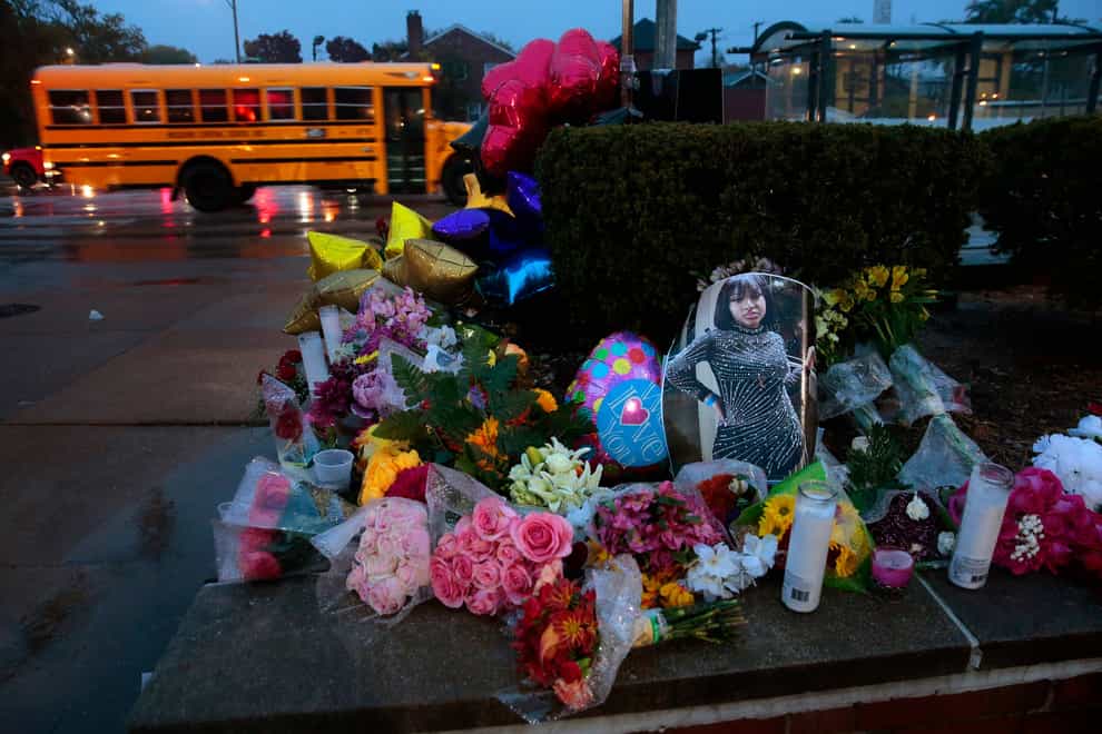 A photo of Alexandria Bell rests at the scene of a growing floral memorial to the victims of a school shooting at Central Visual & Performing Arts High School, Tuesday, Oct. 25, 2022, in St. Louis (Robert Cohen/St Louis Post-Dispatch via AP/PA)