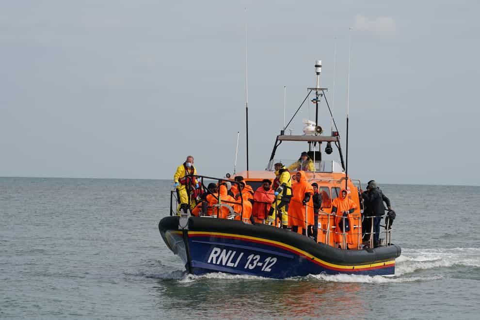 A group of people thought to be migrants are brought in to Dungeness beach by the Dungeness lifeboat following a small boat incident in the Channel. Picture date: Wednesday October 12, 2022 (Gareth Fuller/PA)