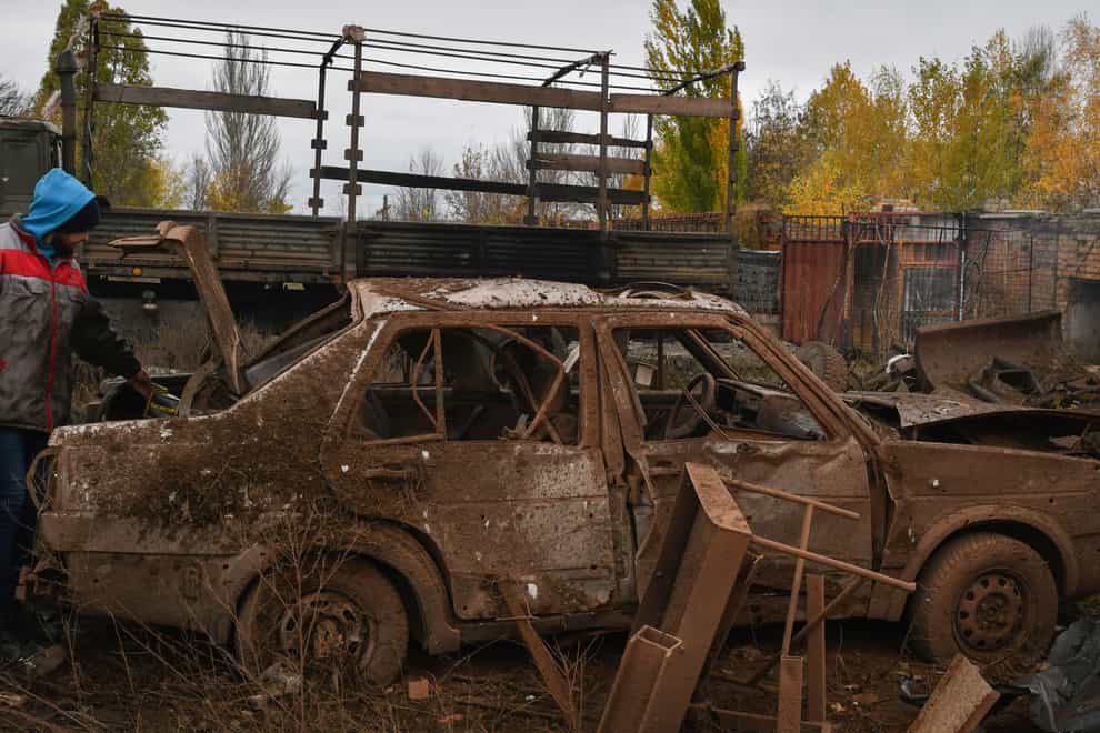 A man stands next to his car that was damaged after an overnight Russian attack in Kramatorsk, Ukraine (AP Photo/Andriy Andriyenko)