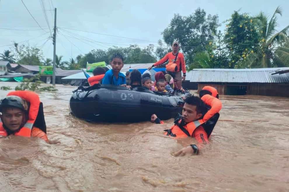 Rescuers use boats to evacuate residents from flooded areas due to Tropical Storm Nalgae at Parang, Maguindanao province (Coast Guard via AP)