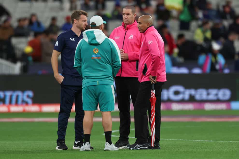 Umpires Joel Wilson, right and Chris Brown talk with rival captains England’s Jos Buttler, left, and Australia’s Aaron Finch (Asanka Brendon Ratnayake/AP)