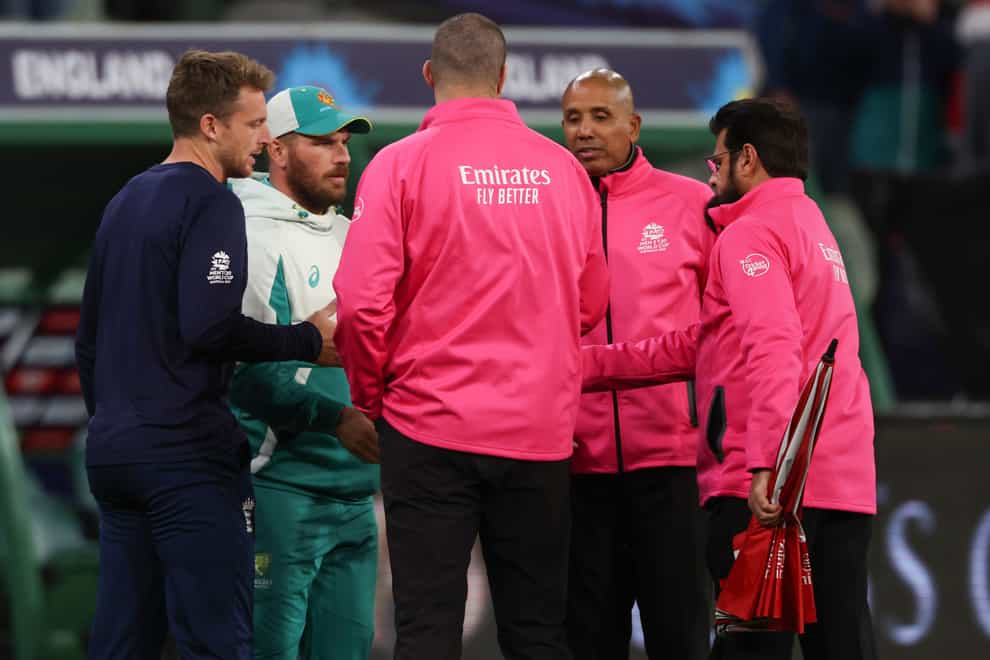 Rival captains England’s Jos Buttler, left, and Australia’s Aaron Finch shake hands with umpires Aleem Dar, right, Joel Wilson, second right, and Chris Brown (Asanka Brendon Ratnayake/AP)