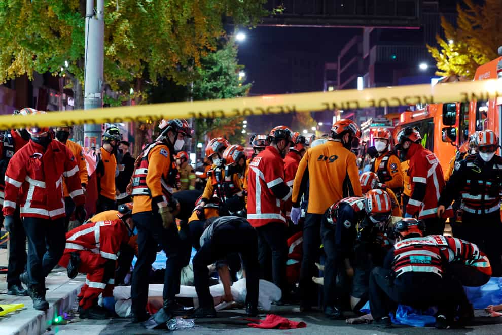 Rescue workers and firefighters work on the scene of a crushing accident in Seoul, South Korea (Lee Ji-eun/Yonhap via AP)