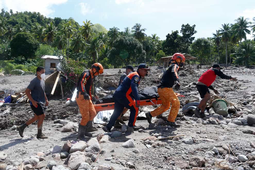 Victims of a huge mudslide set off by Tropical Storm Nalgae in a coastal Philippines village that had once been devastated by a tsunami mistakenly thought a tidal wave was coming and ran towards higher ground and were buried alive, an official said (AP)