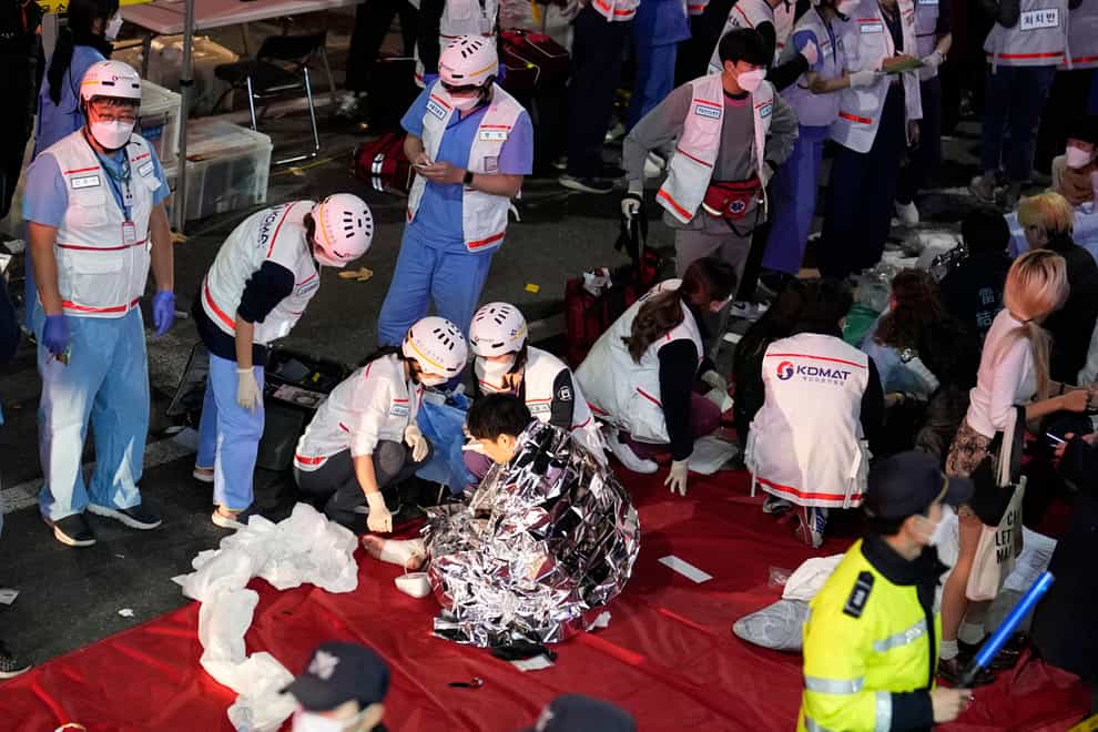 More than 150 people died and many others were injured when a crowd celebrating Halloween became trapped and crushed in a narrow alley in Seoul (Lee Jin-man/AP)