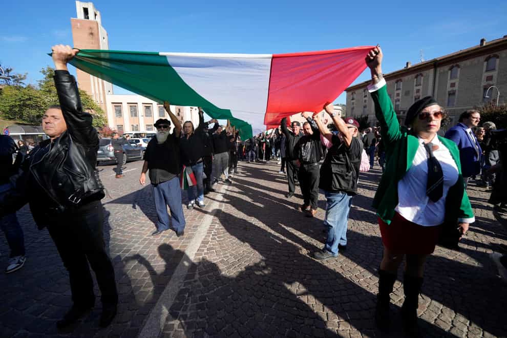 People march in the hometown of former dictator Benito Mussolini to mark the 100th anniversary of the coup d’etat by which he seized power in 1922, in Predappio, Italy (Luca Bruno/PA)