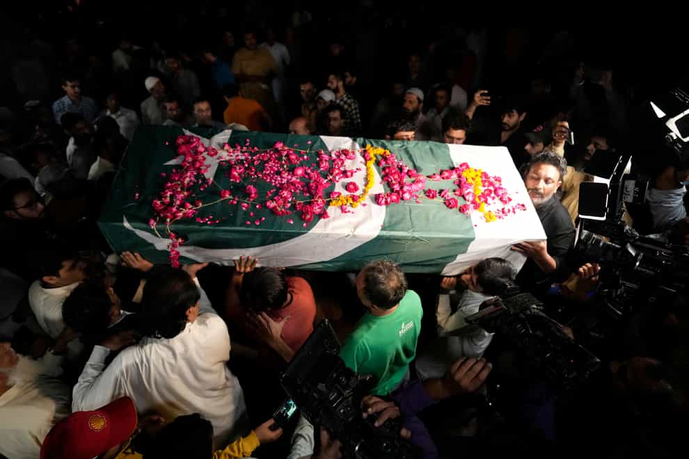 People carry the body of a female journalist during her funeral ceremony in Lahore (KM Chaudary/AP)