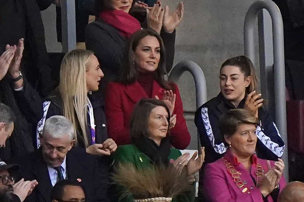 The Princess of Wales applauds at the final whistle, alongside England women’s players Jodie Cunningham (left) and Emily Rudge after the Rugby League World Cup quarter final match at the DW Stadium, Wigan. Picture date: Saturday November 5, 2022.