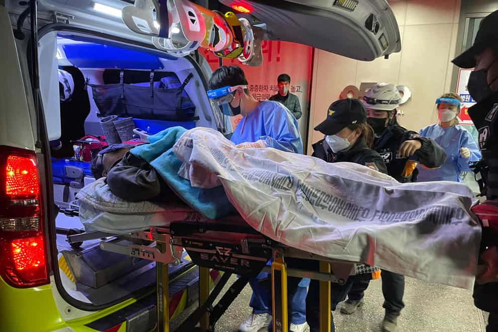 A miner rescued from a collapsed mine is carried into hospital in Bonghwa, South Korea (Kim Jin-hwan/Yonhap via AP)