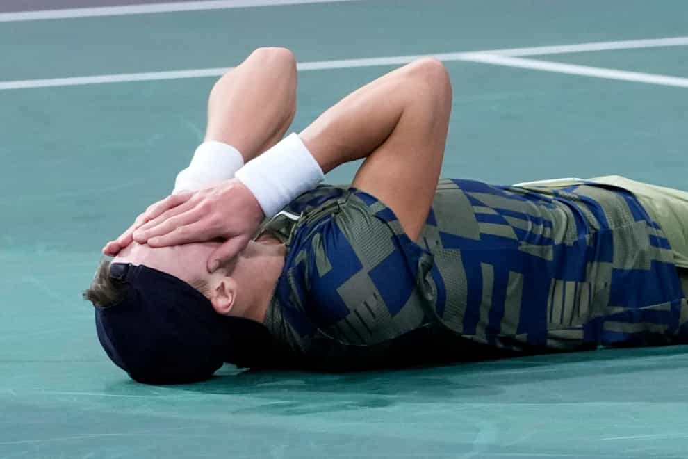 Holger Rune reacts after beating Novak Djokovic in Paris (Thibault Camus/AP)