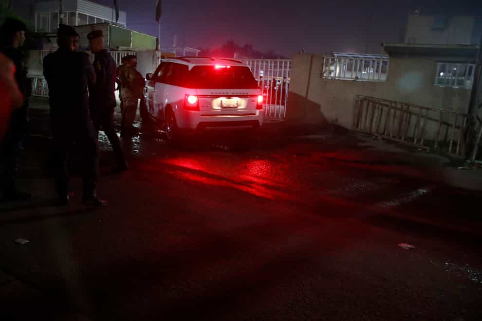 Iraqi security forces gather outside a morgue of Sheik Zayed hospital in Baghdad (Hadi Mizban/AP)