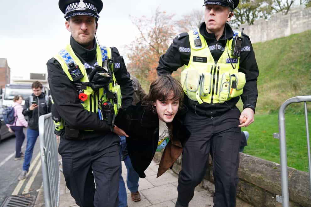 Police detain a protester after he appeared to throw eggs at the King and Queen Consort as they arrived for a ceremony at Micklegate Bar in York, where the Sovereign is traditionally welcomed to the city (Jacob King/PA)
