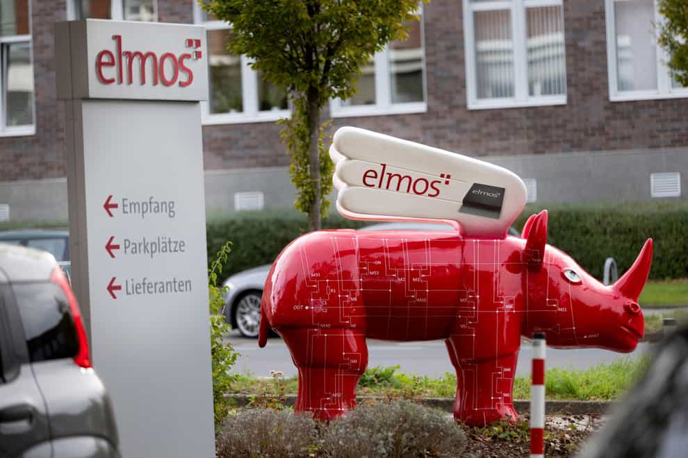 A winged ‘Elmos rhinoceros’ stands in front of the chip factory Elmos Semiconductor SE offices in Dortmund (dpa via AP)