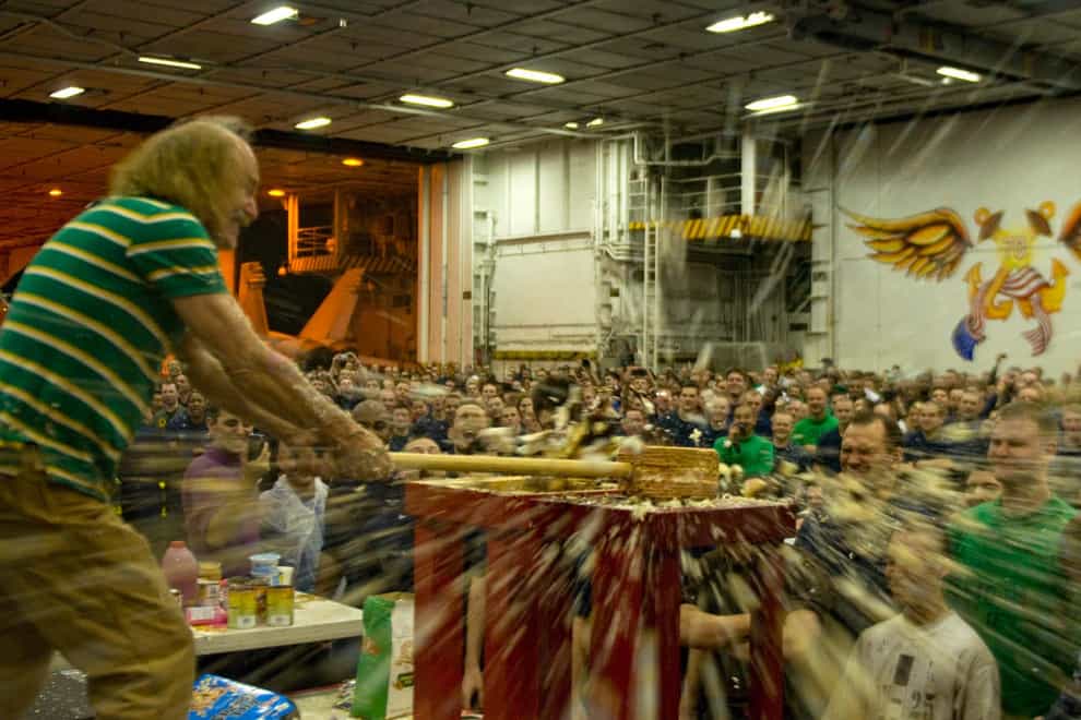 Stand-up comedian Gallagher smashes a cake for sailors aboard the aircraft carrier USS Carl Vinson (Alamy)