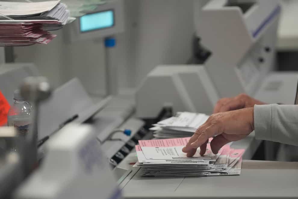 An election worker processes ballots at the Clark County Election Department, in Las Vegas (Gregory Bull/PA)
