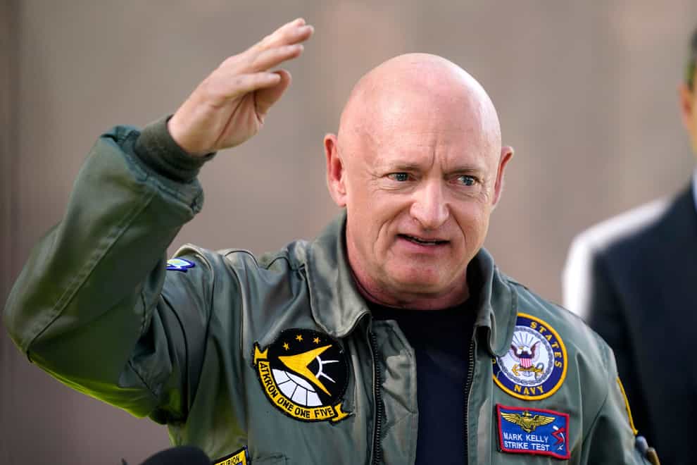 Mark Kelly speaks during a news conference (Ross D Franklin/AP)