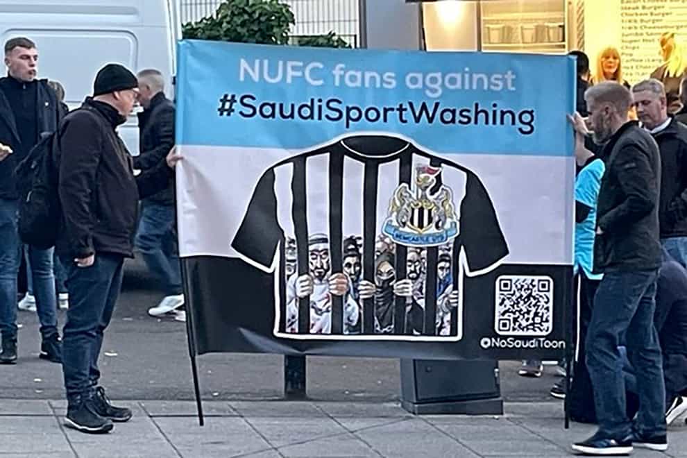 Newcastle fan group NUFC Fans Against Sportswashing hold up a banner outside St James’ Park before the match against Chelsea (Damian Spellman, PA Wire)
