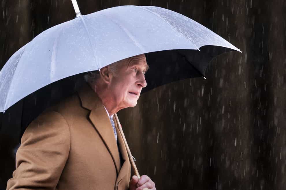 King Charles III shelters under an umbrella outside York Minster this week to attend a short service for the unveiling of a statue of Queen Elizabeth II (Danny Lawson/PA)