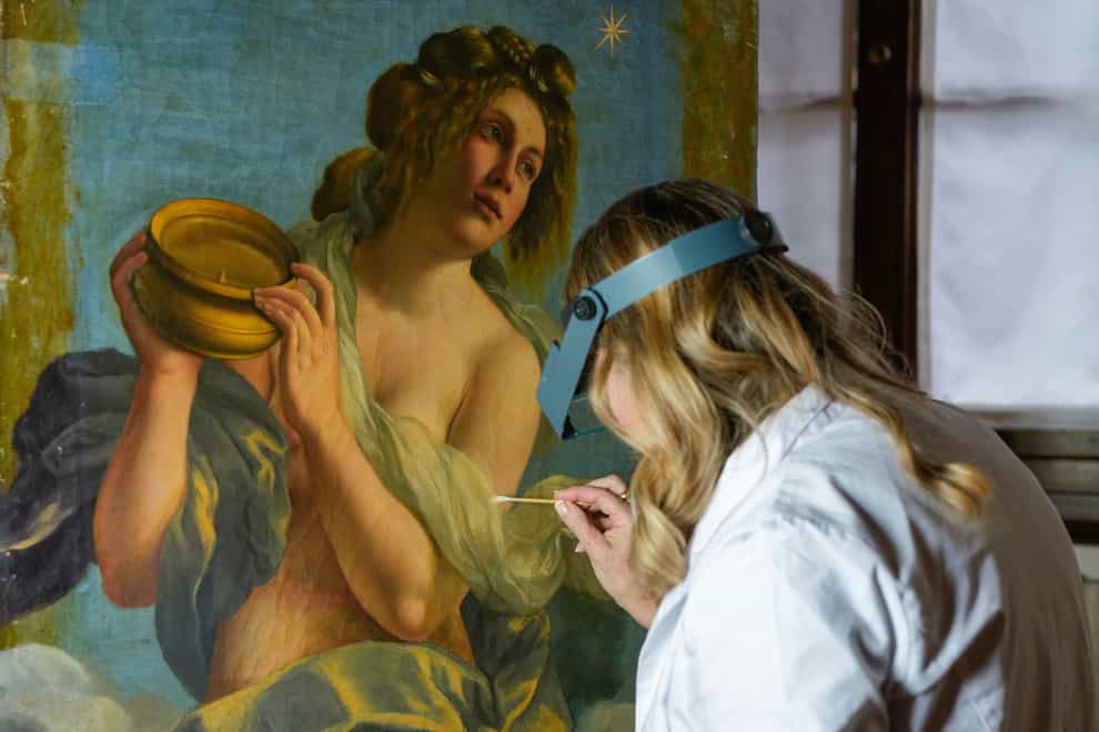 Restorer Elizabeth Wicks works on the Allegory Of Inclination by Artemisia Gentileschi (Andrew Medichini/AP)