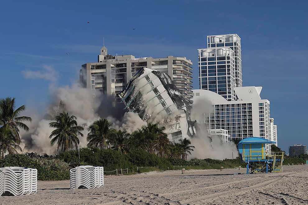 The 17-storey hotel tower of the Deauville Beach Resort on Miami Beach implodes (Carl Juste/Miami Herald via AP)