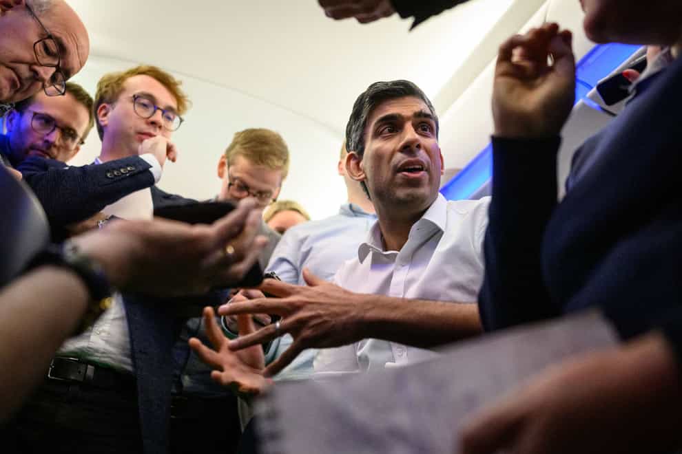 Prime Minister Rishi Sunak holds a ‘huddle’ press conference with political journalists on board a Government plane as he heads to Bali to attend the G20 summit (Leon Neal/PA)