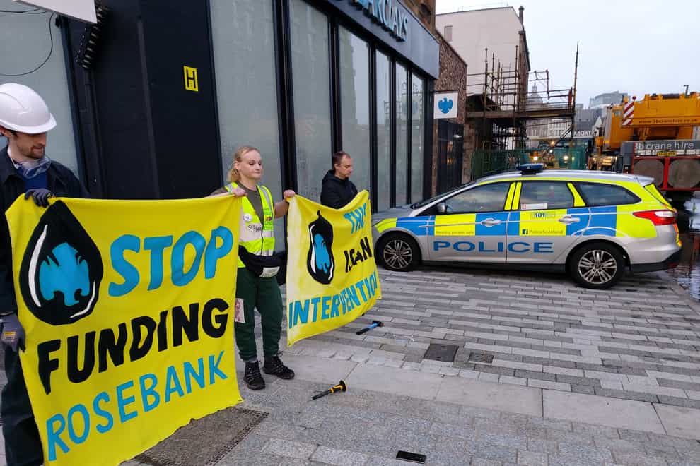 Protesters outside a branch of Barclays in Glasgow after its windows were broken (Extinction Rebellion/PA)