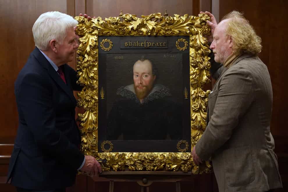 Conservator Adrian Phippen (right) and art and antiques writer Duncan Phillipps with a portrait said to be of William Shakespeare by artist Robert Peake (Kirsty O’Connor/PA)