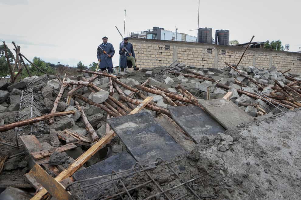 Kenyan police attend the scene of a building collapse in Ruaka, on the outskirts of the capital Nairobi, Kenya Thursday, Nov. 17, 2022. The collapse of the building under construction is the second such collapse in a matter of days in Nairobi, where housing is in high demand and unscrupulous developers often bypass regulations. (AP Photo)