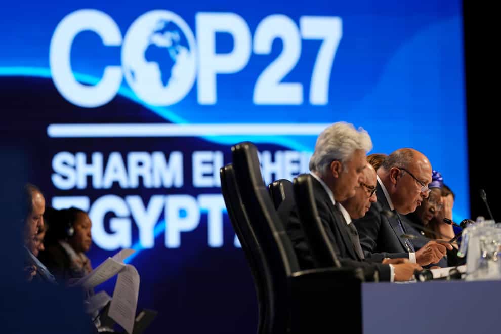Sameh Shoukry, president of the Cop27 climate summit, right, speaks during a closing plenary session at the UN climate summit (Peter Dejong/AP)