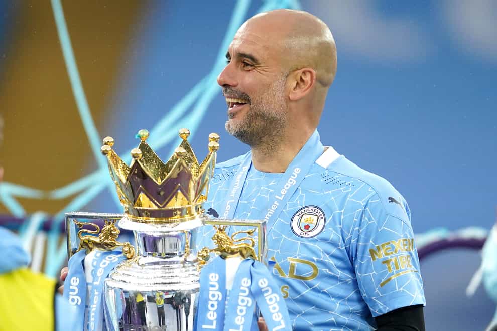 Manchester City manager Pep Guardiola with the Premier League trophy (Dave Thompson/PA).