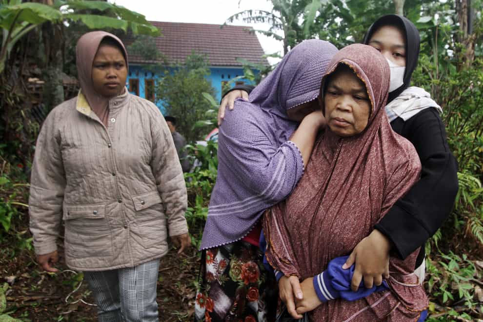 Women weep as the body of a family member killed in Monday’s earthquake is taken away for burial in Cianjur, West Java (AP)