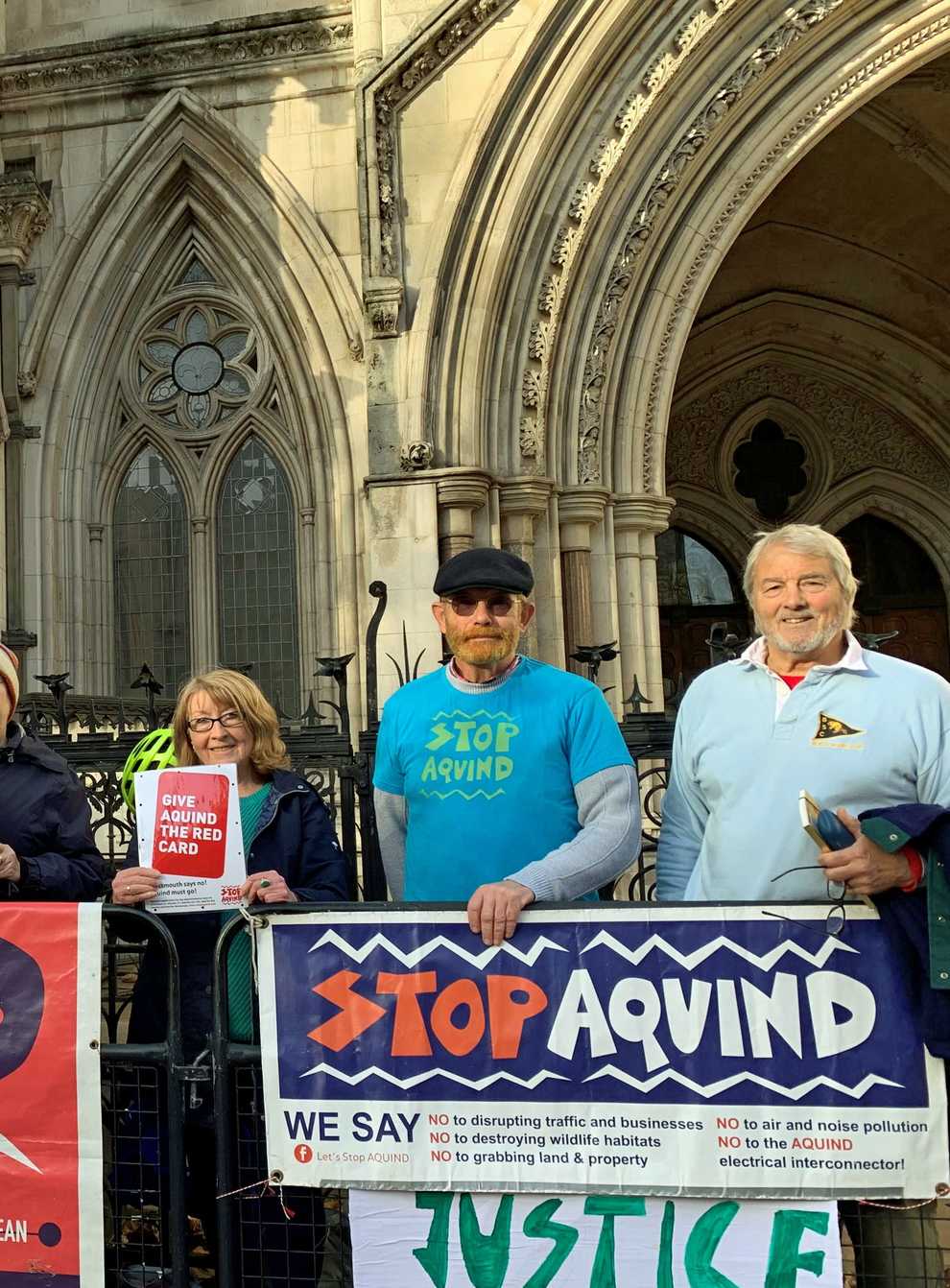Portsmouth residents and members of the community campaign group Let’s Stop Aquind, outside the Royal Courts of Justice in London (Tom Pilgrim/PA)
