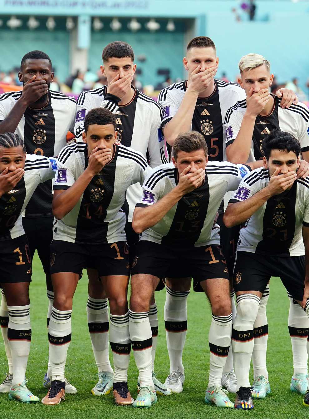 Germany’s players cover their mouths in protest at being blocked from wearing the OneLove armband (Mike Egerton/PA)