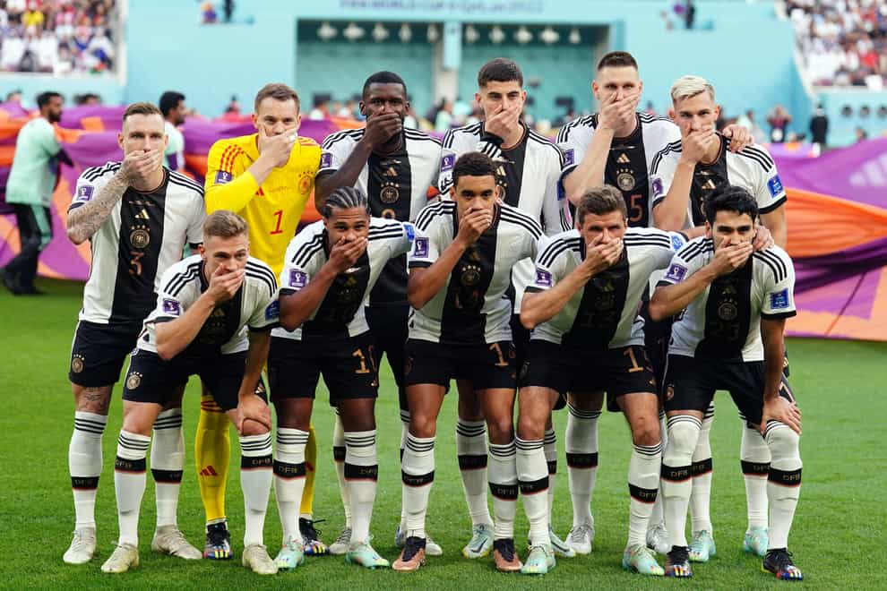 Germany’s players cover their mouths in protest at being blocked from wearing the OneLove armband (Mike Egerton/PA)