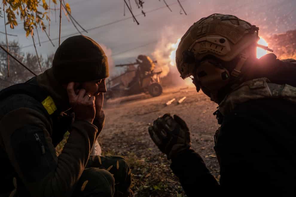 Ukrainian servicemen fire towards Russian positions in the frontline near Kherson, southern Ukraine (AP)