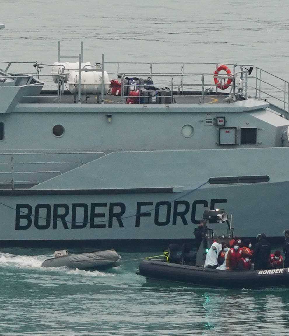 A group of people thought to be migrants being brought in to Dover, Kent, by Border Force officers, following a small boat incident in the Channel. Picture date: Thursday December 16, 2021 (Gareth Fuller/PA)