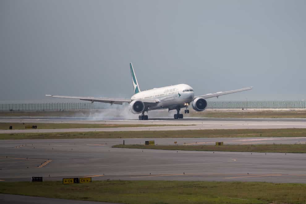 A Cathay Pacific airplane lands on the new third runway at Hong Kong International Airport (Vernon Yuen/AP)