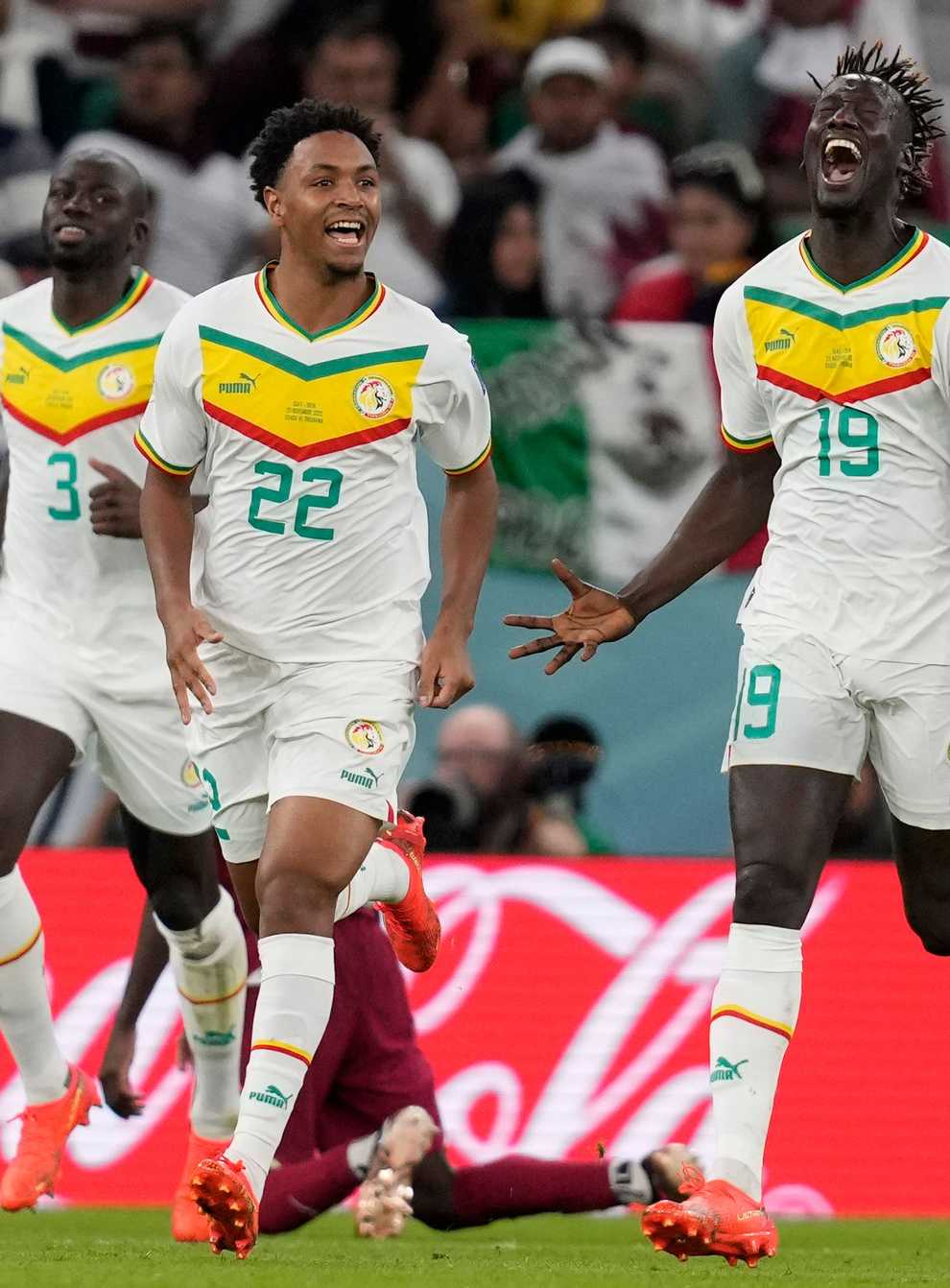 Senegal’s Famara Diedhiou, right, celebrates after scoring his side’s second goal against World Cup hosts Qatar (Thanassis Stavrakis/AP)