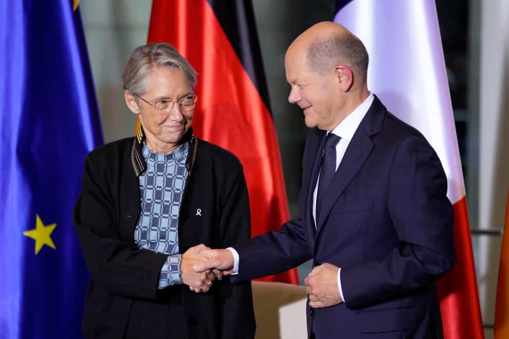 Chancellor Olaf Scholz and Prime Minister Elisabeth Borne shake hands after signing the agreement (AP Photo/Michael Sohn)