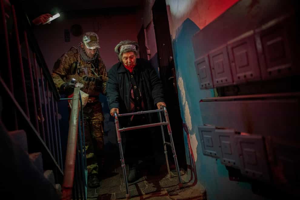 Elderly residents are evacuated from the southern city of Kherson (AP)