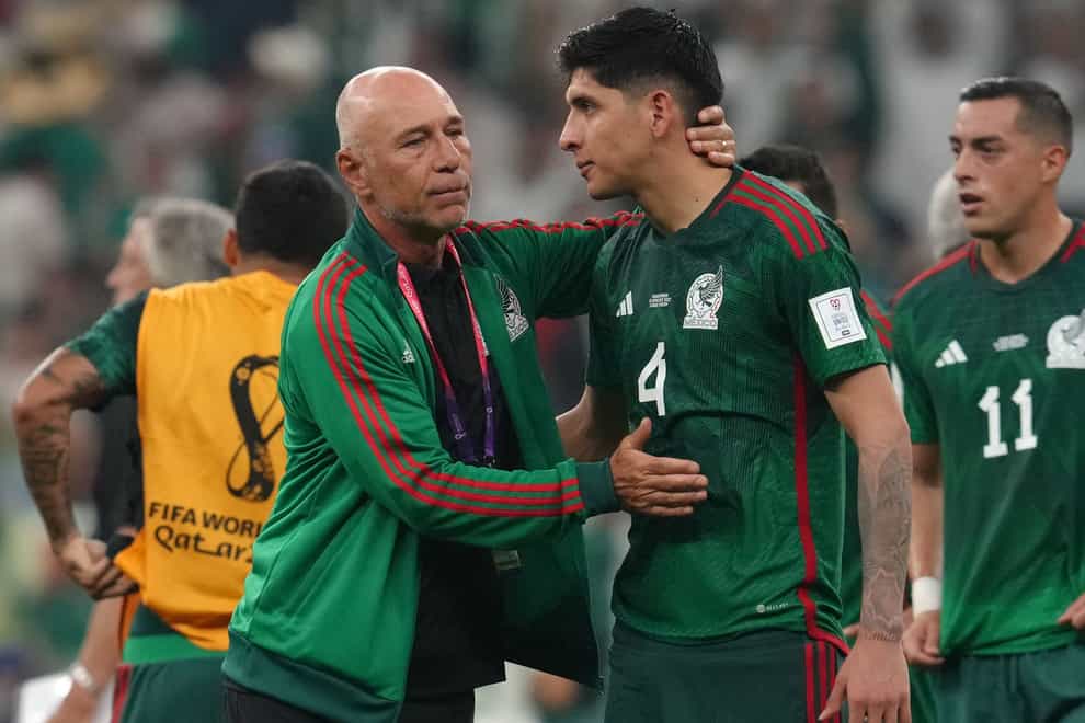 Edson Alvarez (right) is consoled after Mexico beat Saudi Arabia but missed out on a place in the last 16 (Nick Potts/PA)