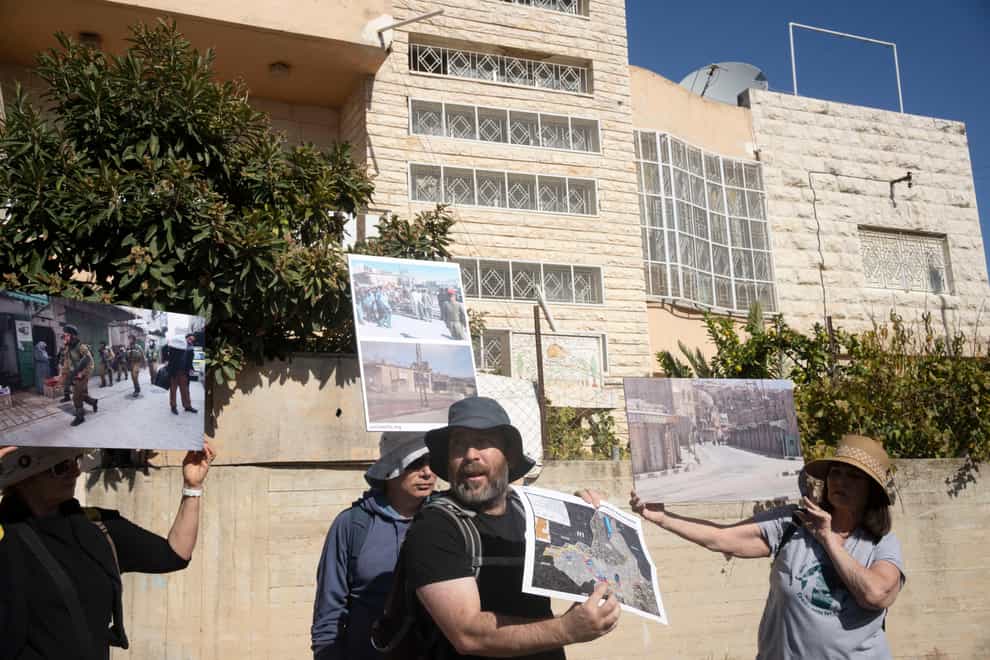 An Israeli activist gives a tour of the embattled West Bank city of Hebron (AP)