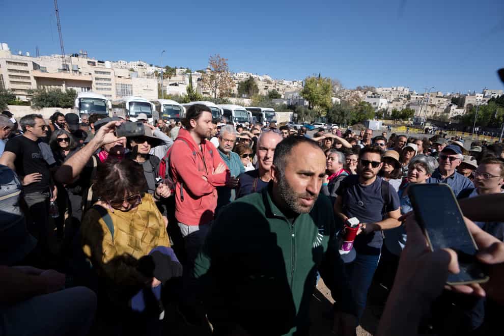 Palestinian activist Issa Amro, center, stands with Israeli activists in the embattled West Bank city of Hebron, Friday, Dec. 2, 2022. Israeli peace activists toured the occupied West Bank’s largest city Friday in a show of solidarity with Palestinians, amid chants of “shame, shame” from ultra-nationalist hecklers (Maya Alleruzzo/AP/PA)