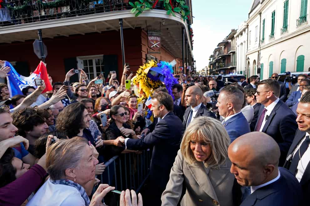 French President Emmanuel Macron and his wife Brigitte Macron greet the crowd as they arrive in New Orleans (Gerald Herbert/PA)