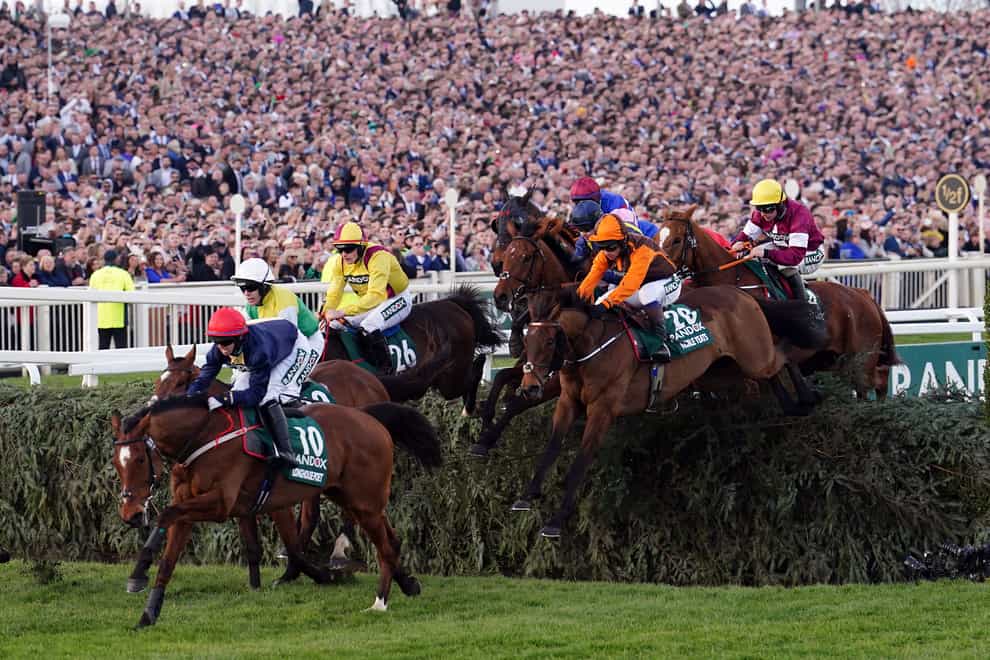 Noble Yeats ridden by jockey Sam Waley-Cohen (no.28) clear a fence on their way to winning the Randox Grand National Handicap Chase during Grand National Day of the Randox Health Grand National Festival 2022 at Aintree Racecourse, Liverpool. Picture date: Saturday April 9, 2022.