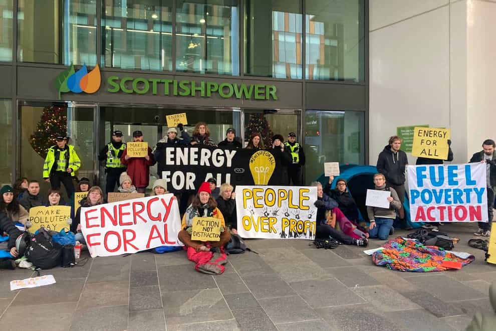 Protesters pose outside Scottish Power HQ in Glasgow as they call for action against fuel poverty